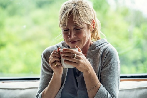 Mature woman having coffee