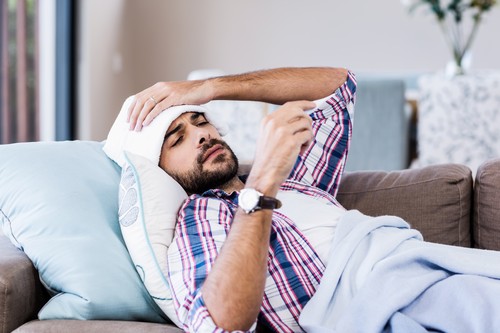 Sick man checking temperature