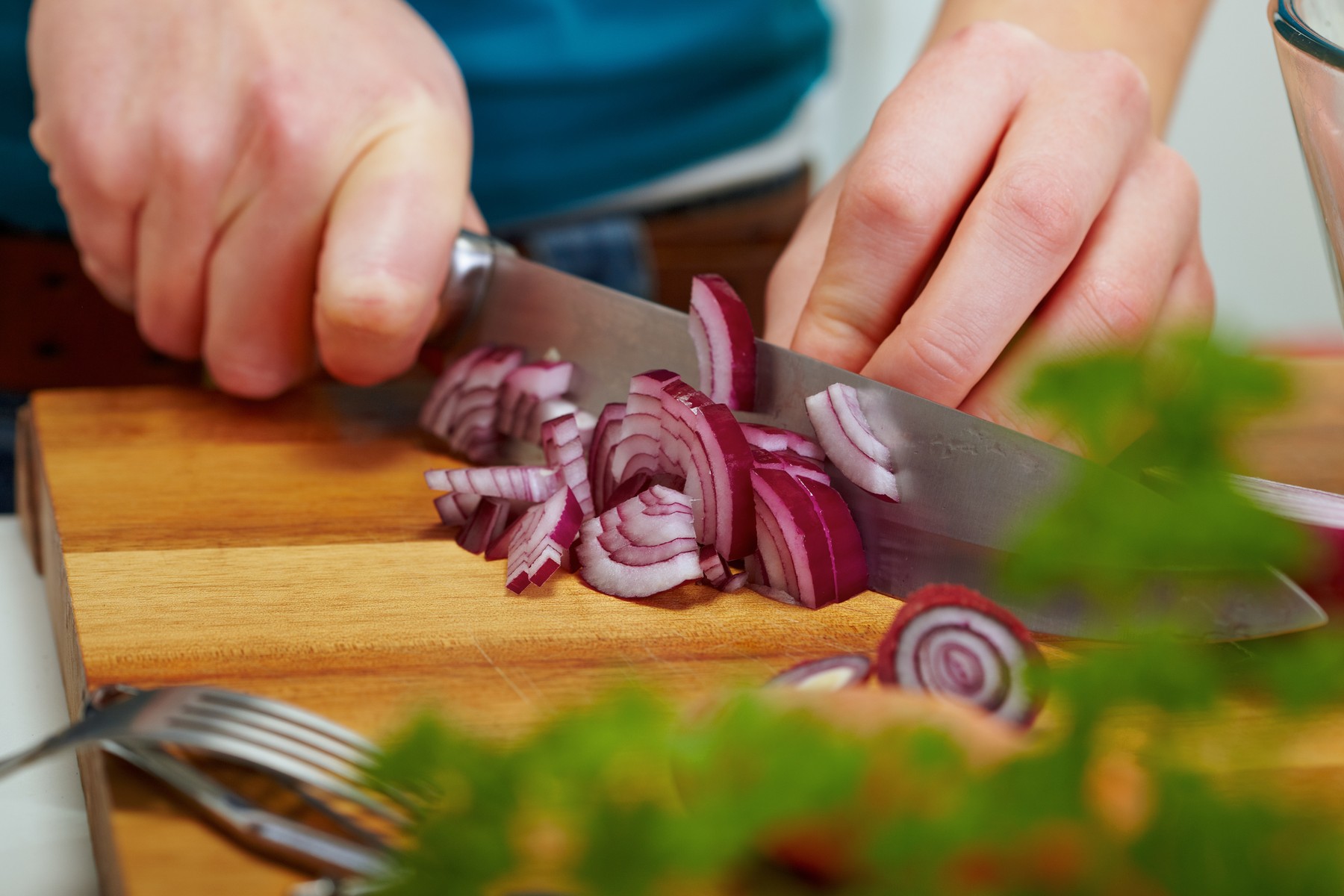 Cutting red onions on cutting board