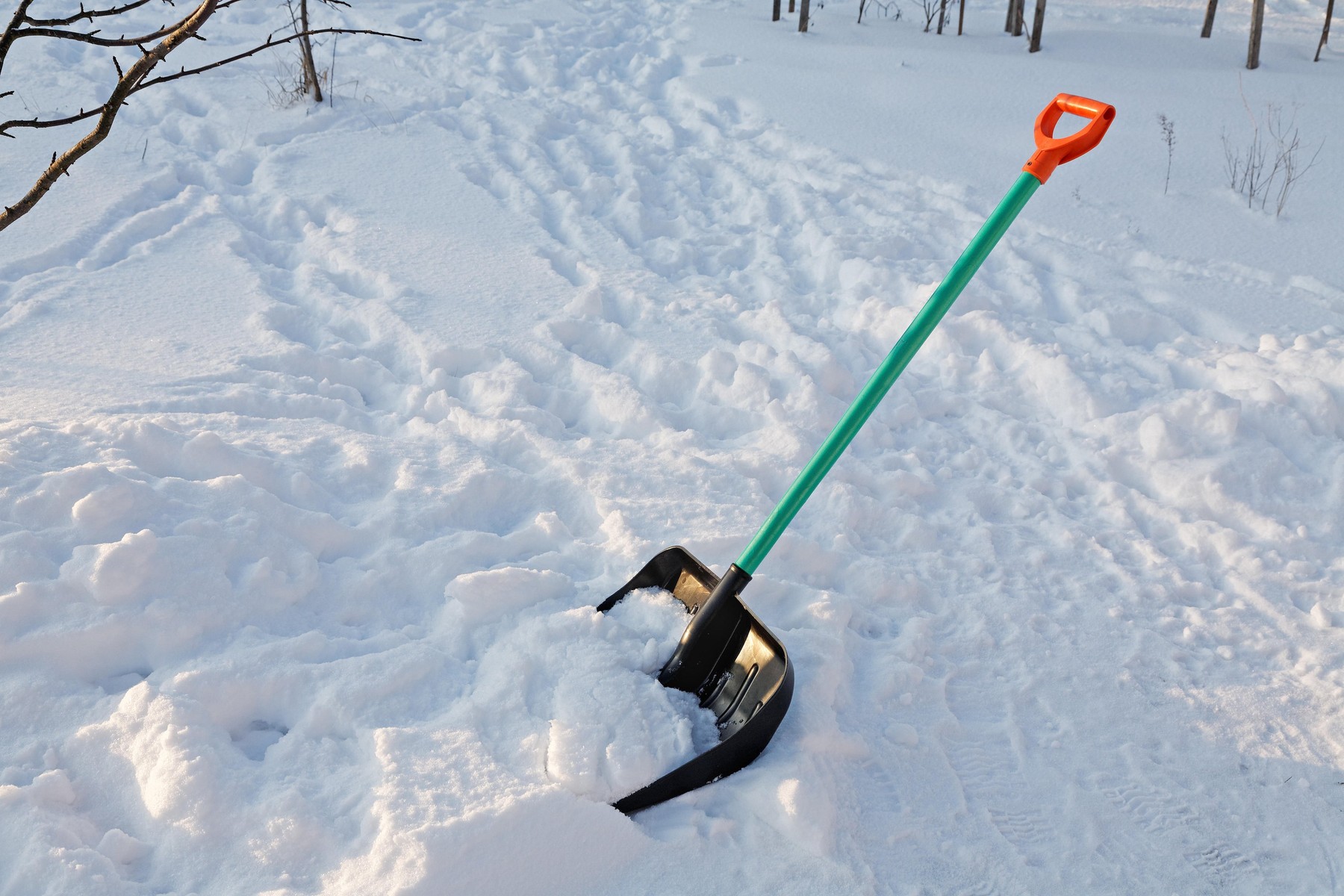 shovel for snow cleaning sticks out in a snowdrift