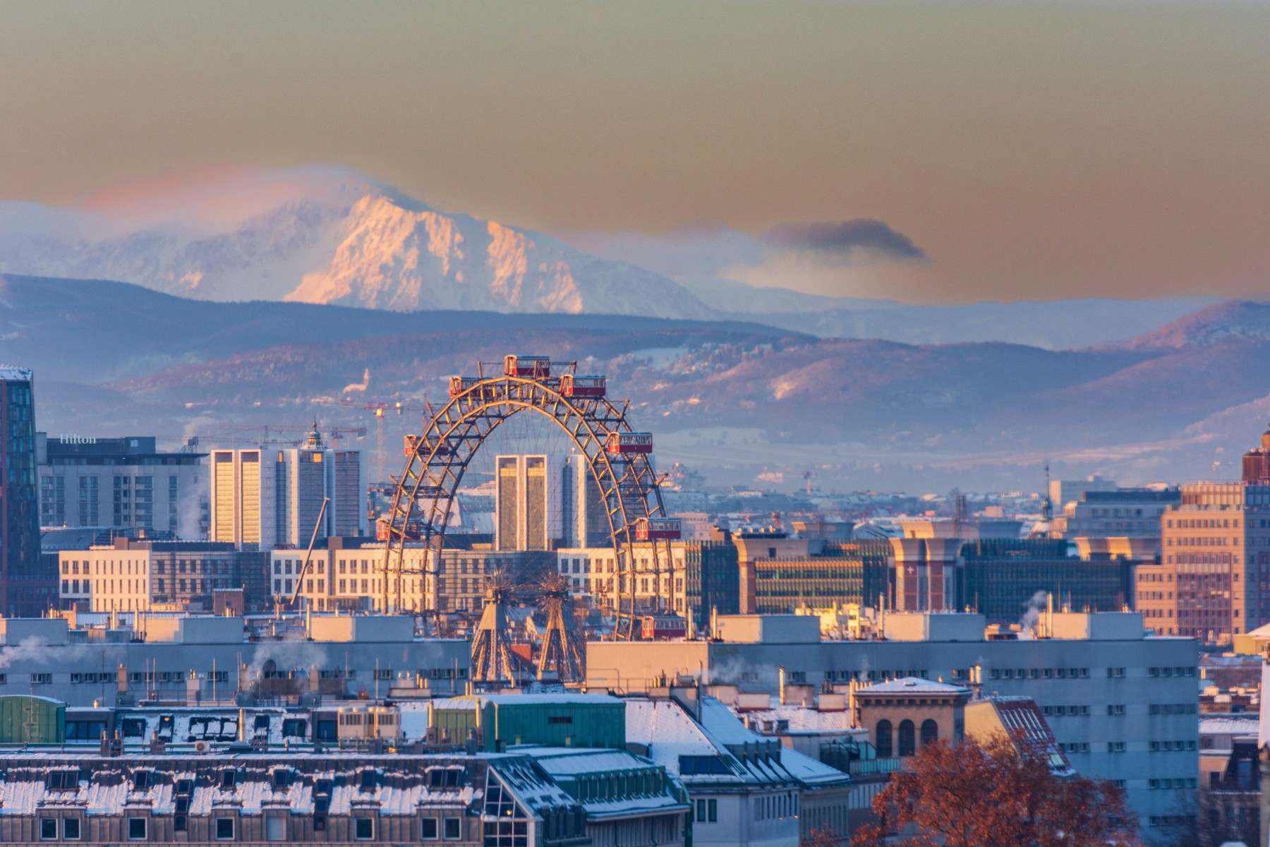 Wien, Vienna: sunrise at Vienna, Ferris Wheel, Prater, snow covered houses and mountain Schneeberg, in 00. overview, Wien, Austria