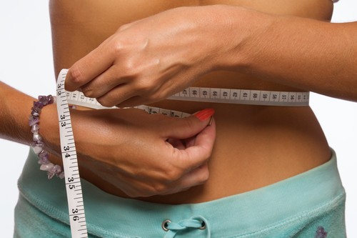 Woman measuring waist