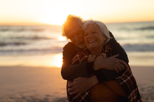 Old couple in love at the beach