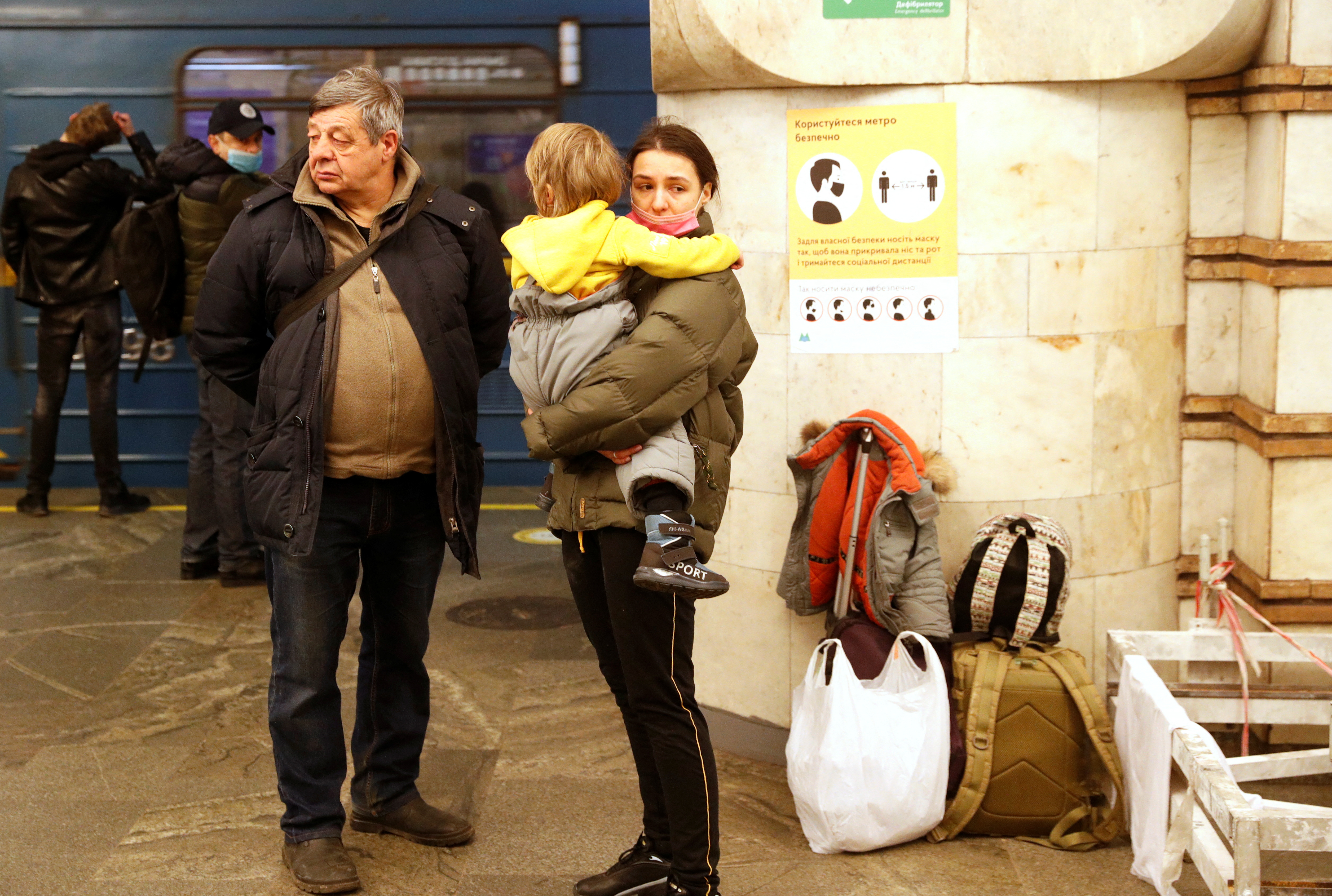 People take shelter in a subway station, after Russian President Vladimir Putin authorized a military operation in eastern Ukraine, in Kyiv