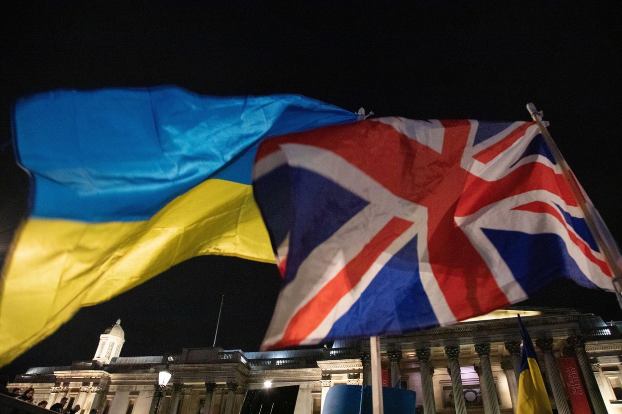 London, England. 3rd March 2022. A British and an Ukrainian Flag together as Ukrainians and supporters of Ukraine have gathered on Trafalgar Square to protest against Russia's invasion of Ukraine.