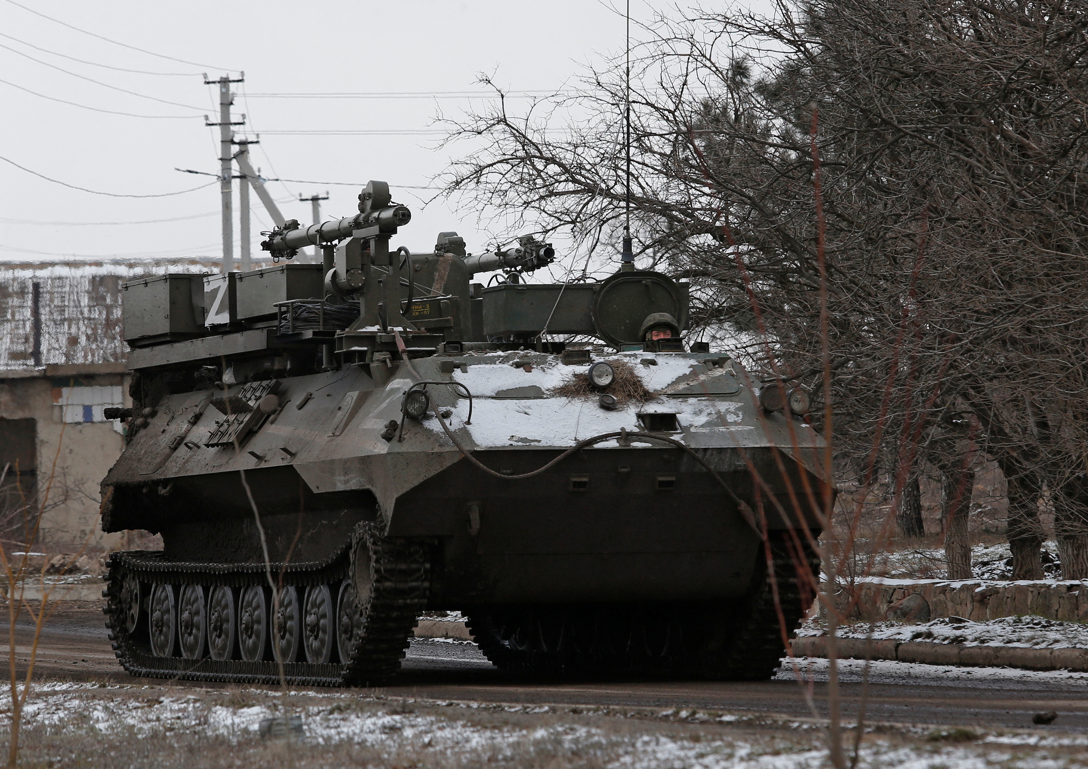 A service member of pro-Russian troops drives an armoured vehicle in the separatist-controlled village of Anadol during Ukraine-Russia conflict in the Donetsk region