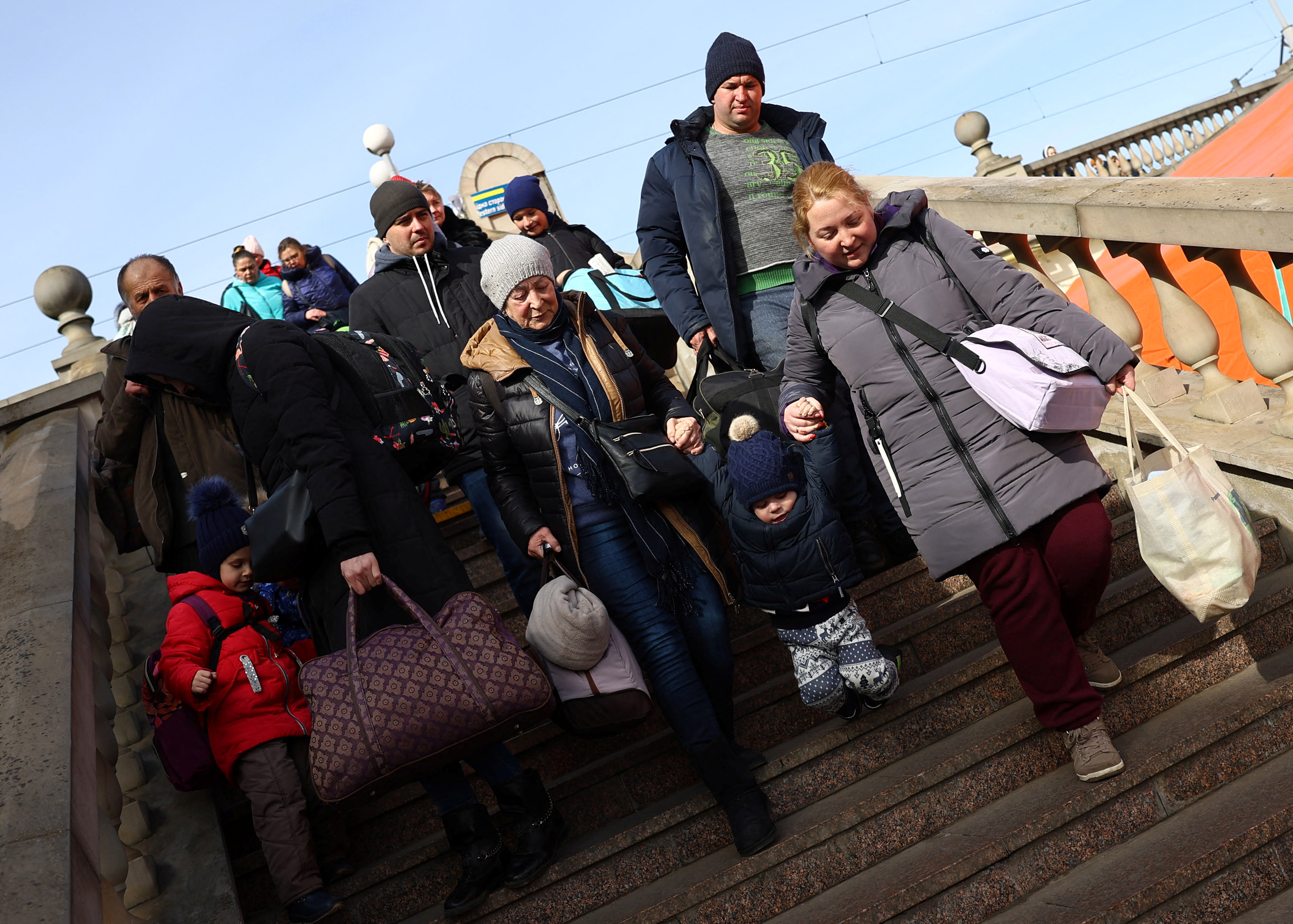 Refugees from the ongoing Russian invasion arrive at a train station in Lviv