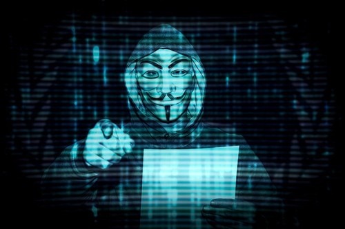 Milan, Italy. February 28th, 2022. Man with a mask from the decentralized group of activists anonymous hackers issues a statement against Putin about
