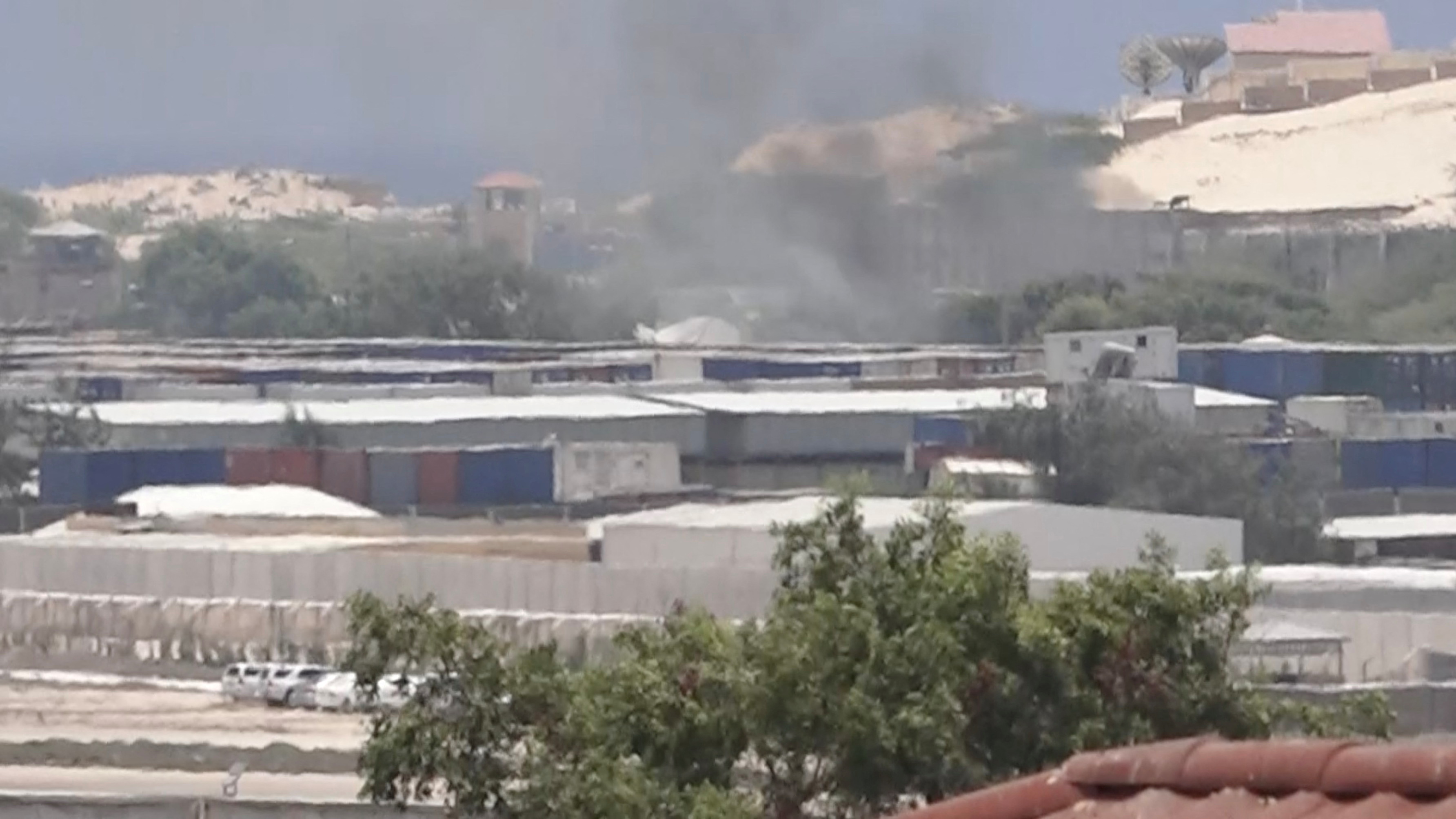 Smoke rises from behind buildings, in Mogadishu