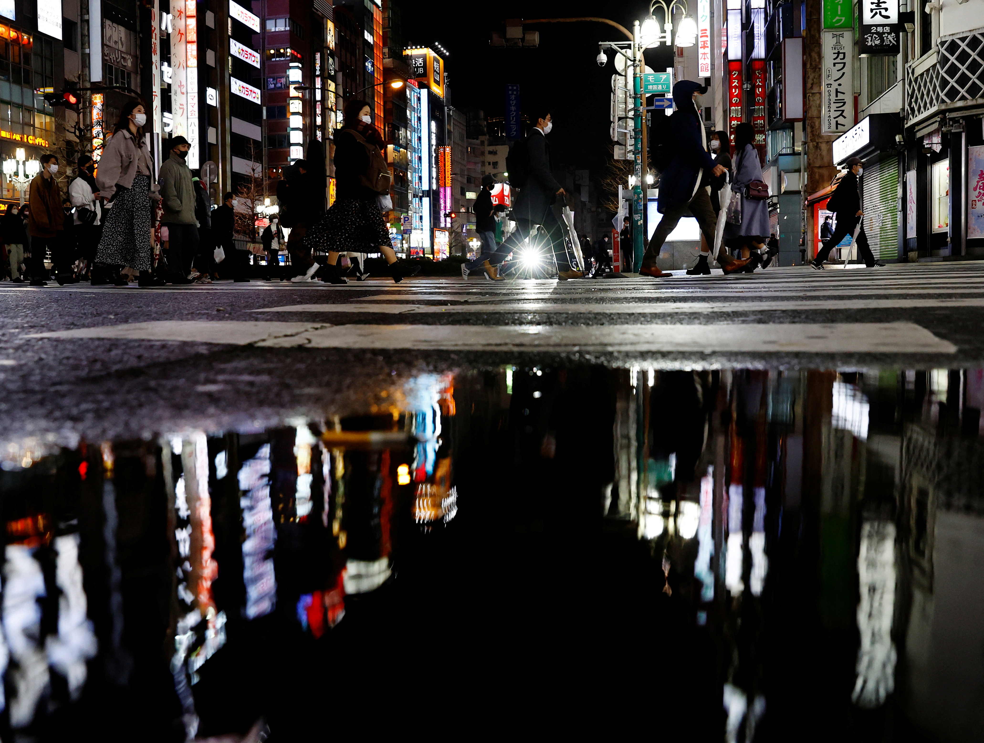 People walk at a street amid the COVID-19 outbreak, in Tokyo