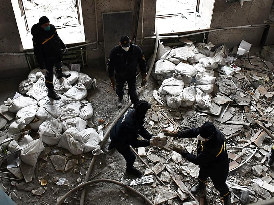 Rescuers work at a site of the regional administration building hit by cruise missiles in Mykolaiv
