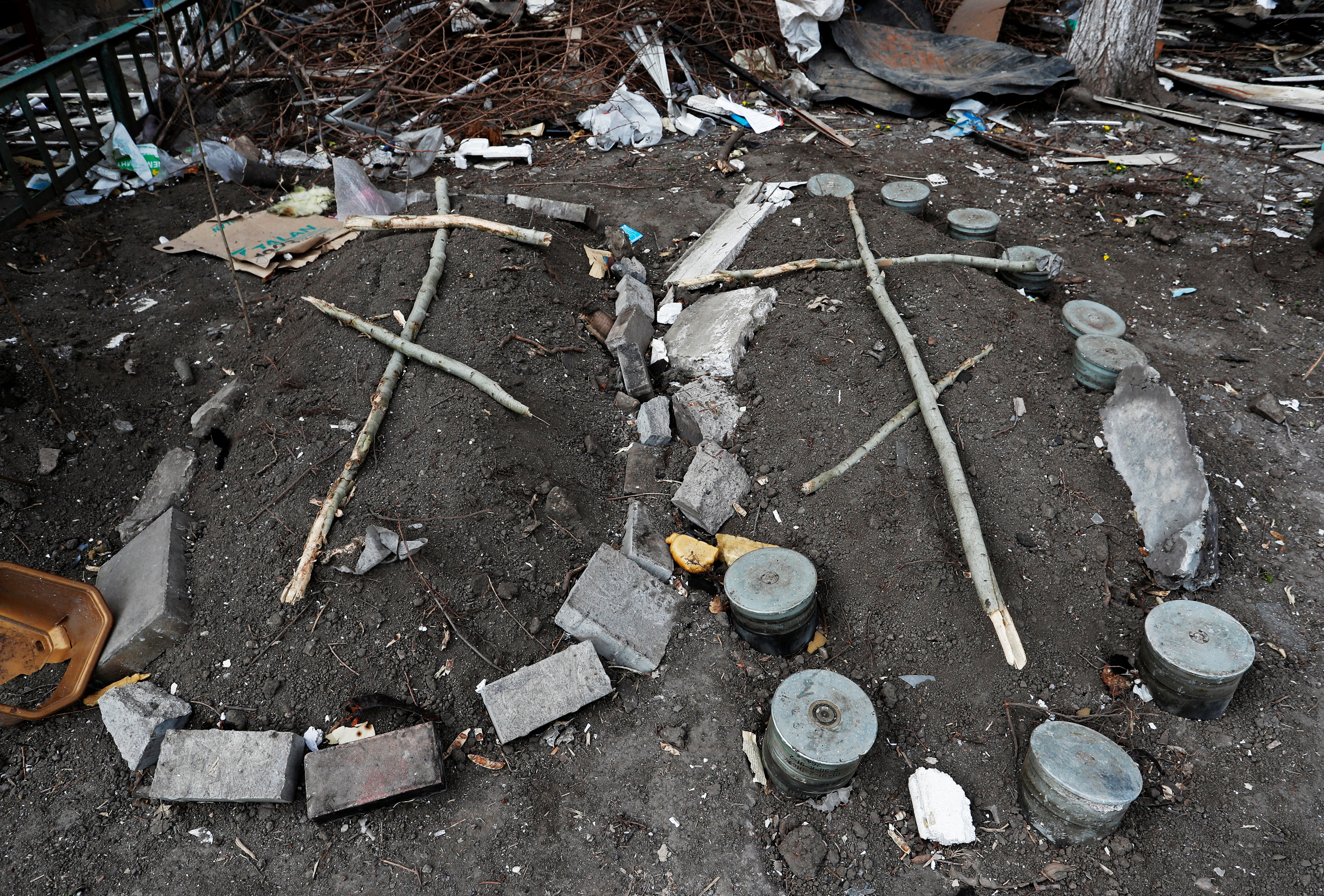 Graves are seen next to an apartment building in Mariupol