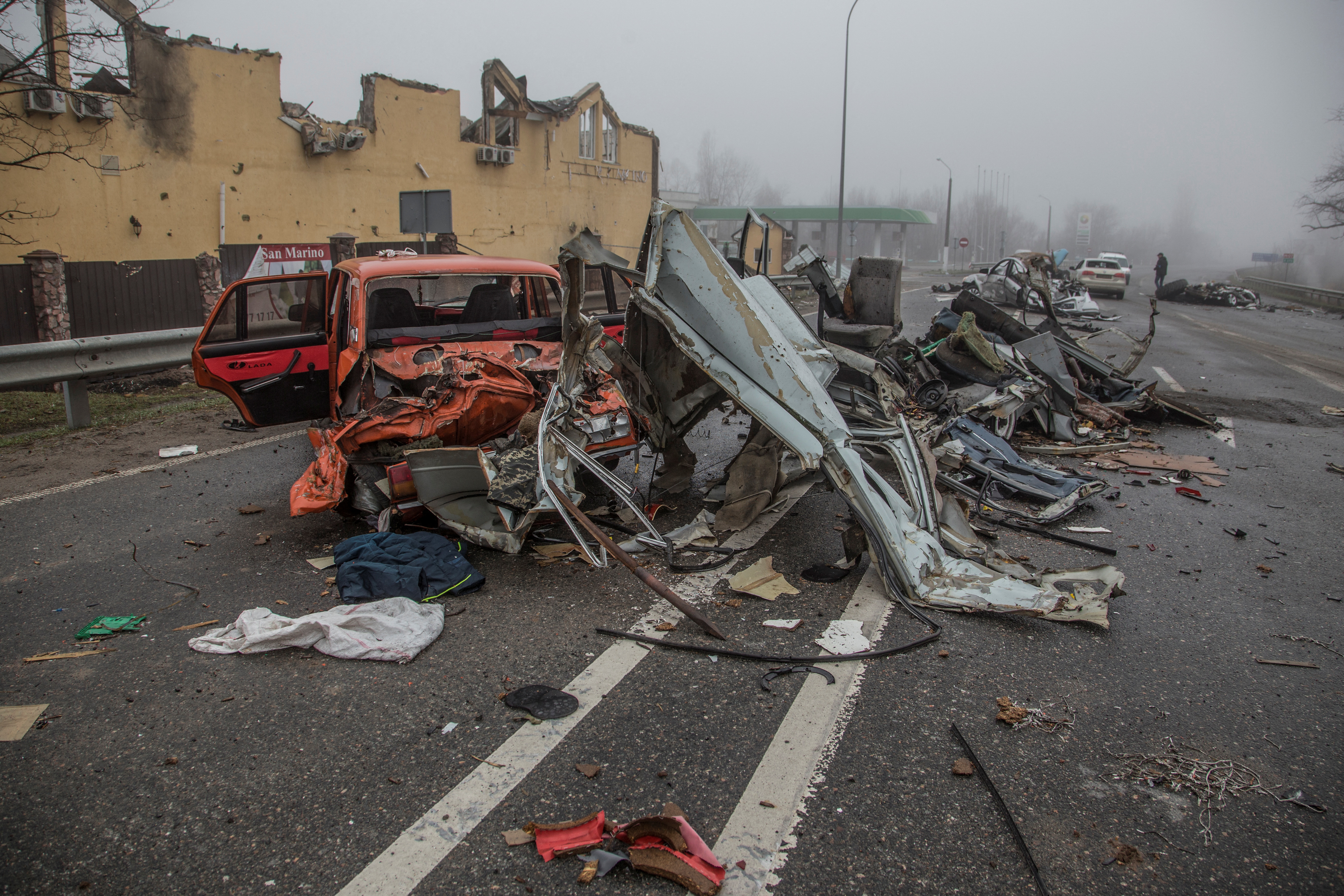 Squashed civilian cars are seen on a street in the town of Bucha