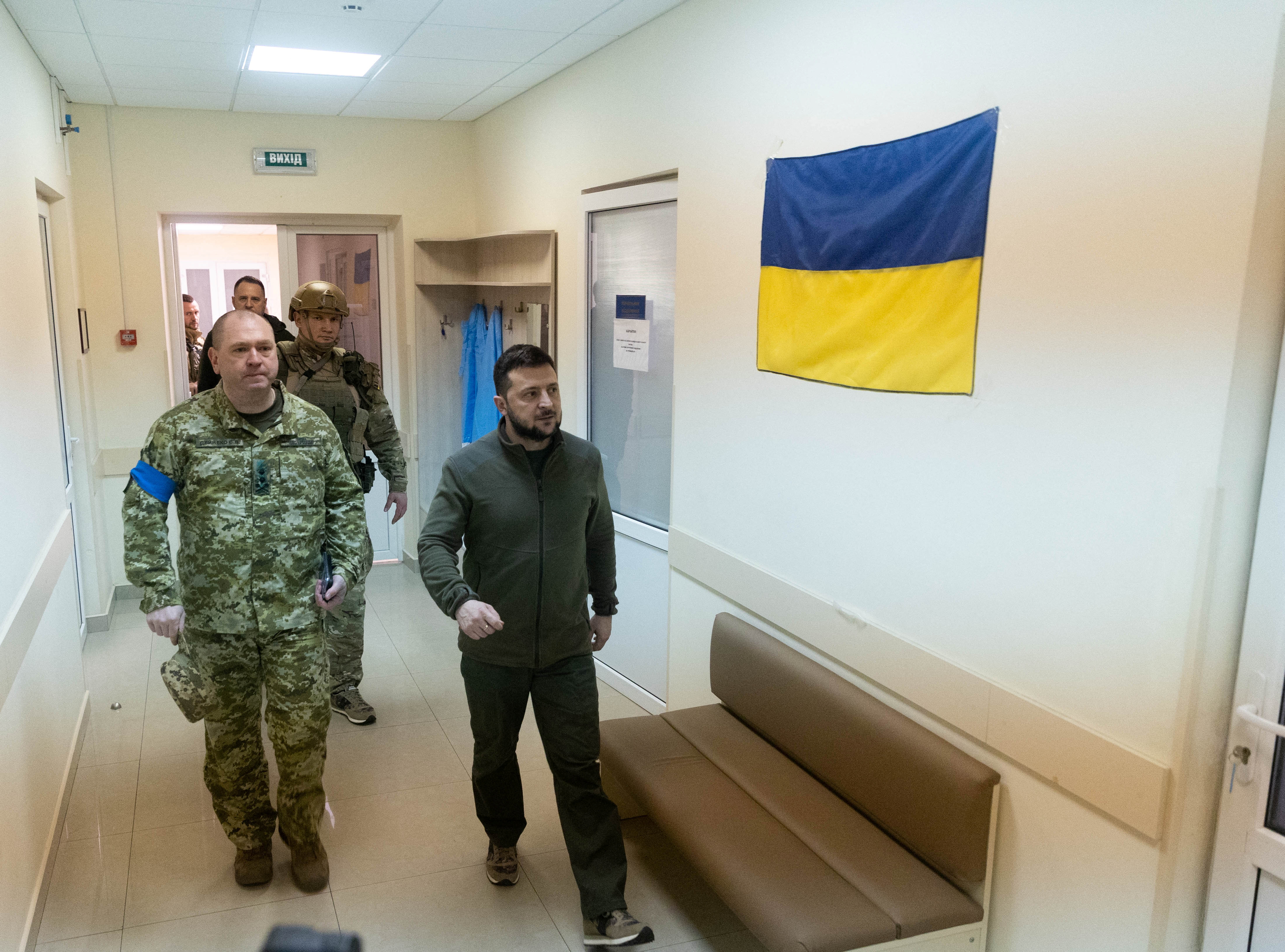 Ukraine's President Zelenskiy and Head of the State Border Guard Service Deineko walk in a corridor of a military hospital in Kyiv