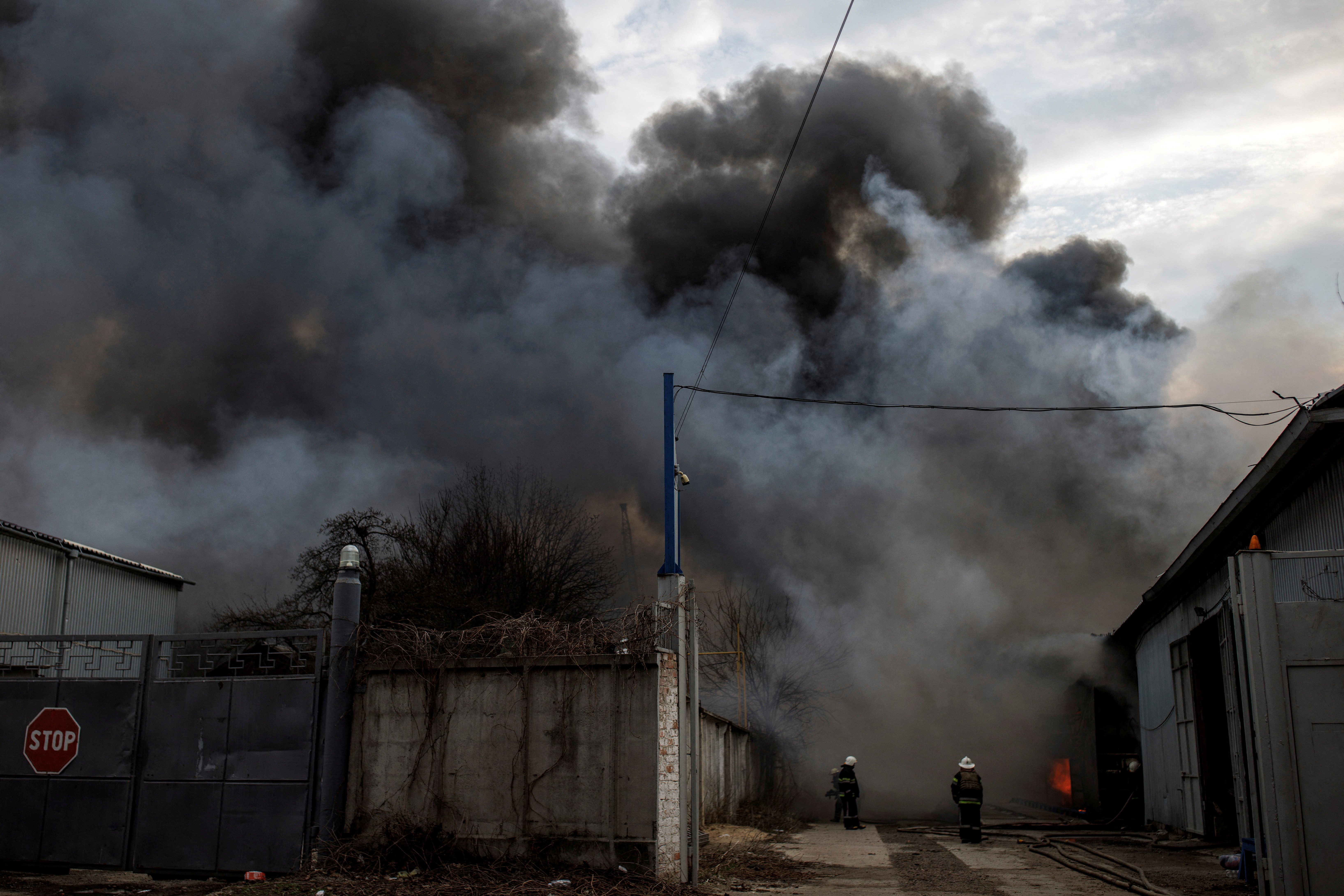 Firefighters try to contain a fire at a plant following Russian shelling, as Russia's attack on Ukraine continues, in Kharkiv