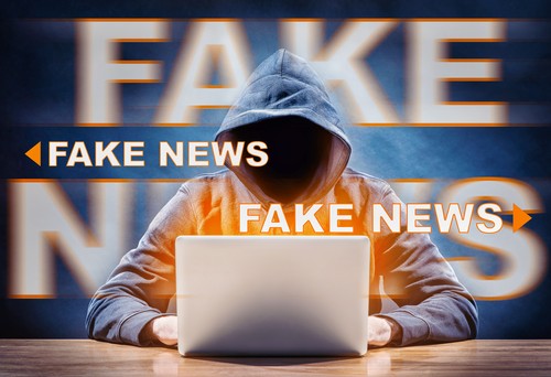 a hacker spreading fake news from a computer