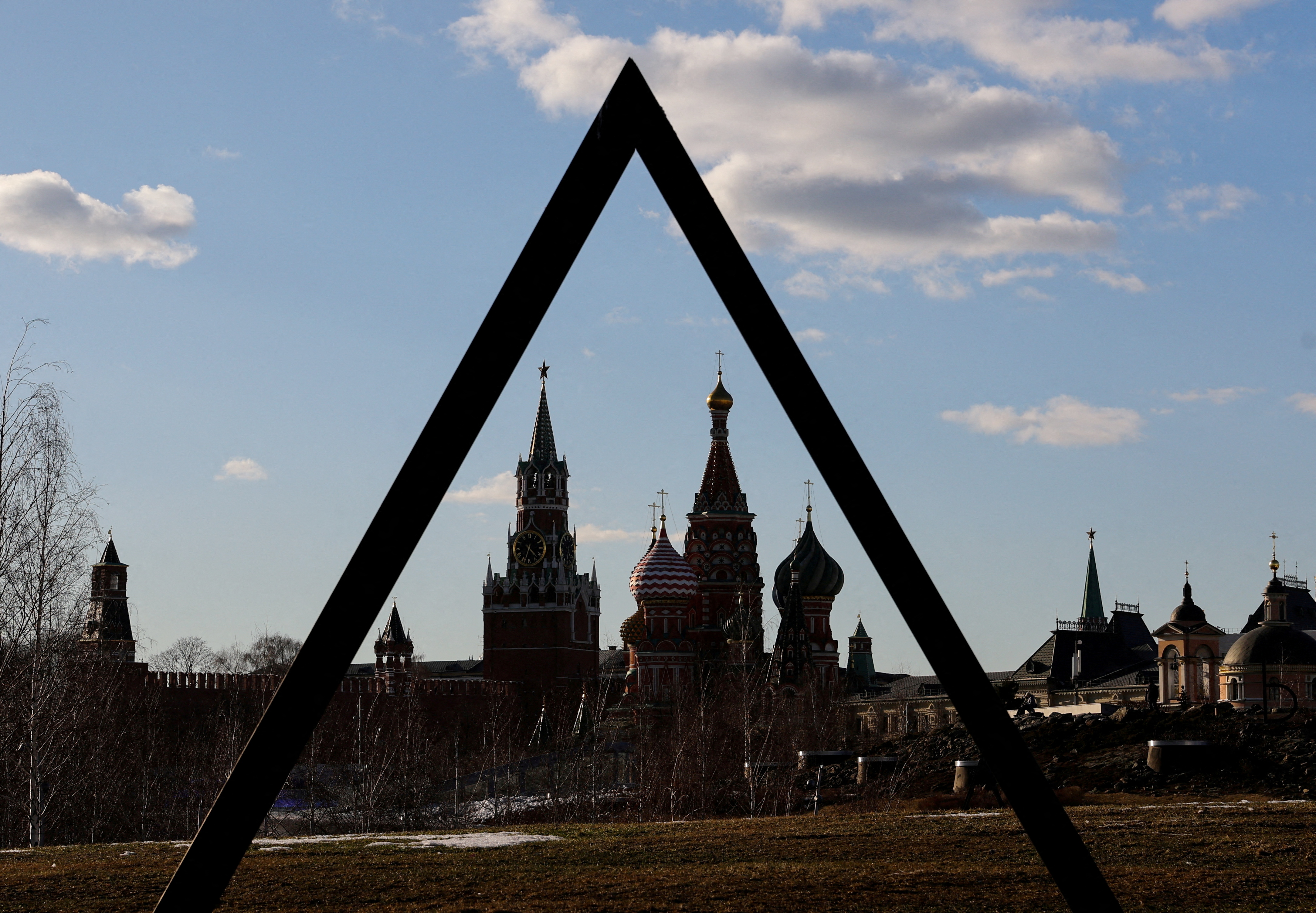 FILE PHOTO: The Kremlin's Spasskaya Tower and St. Basil's Cathedral are seen through the art object in Zaryadye park in Moscow