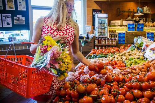 Woman shopping for vegetables in supermarket