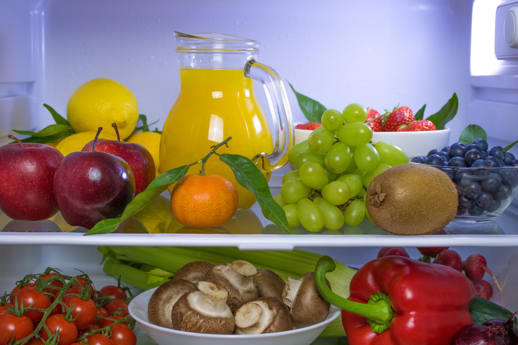 Food photography of a beautifully decorated fridge with fresh, healthy, vegan or plant based food items.