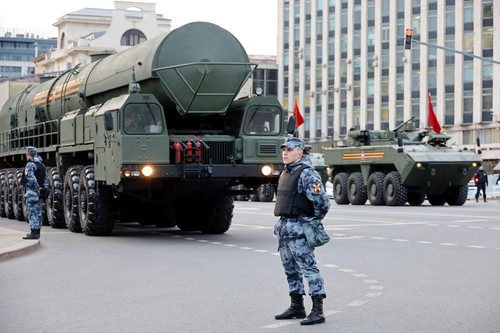 Nuclear weapon of Russia, soldier of russian military forces standing on background of strategic missile system in Moscow