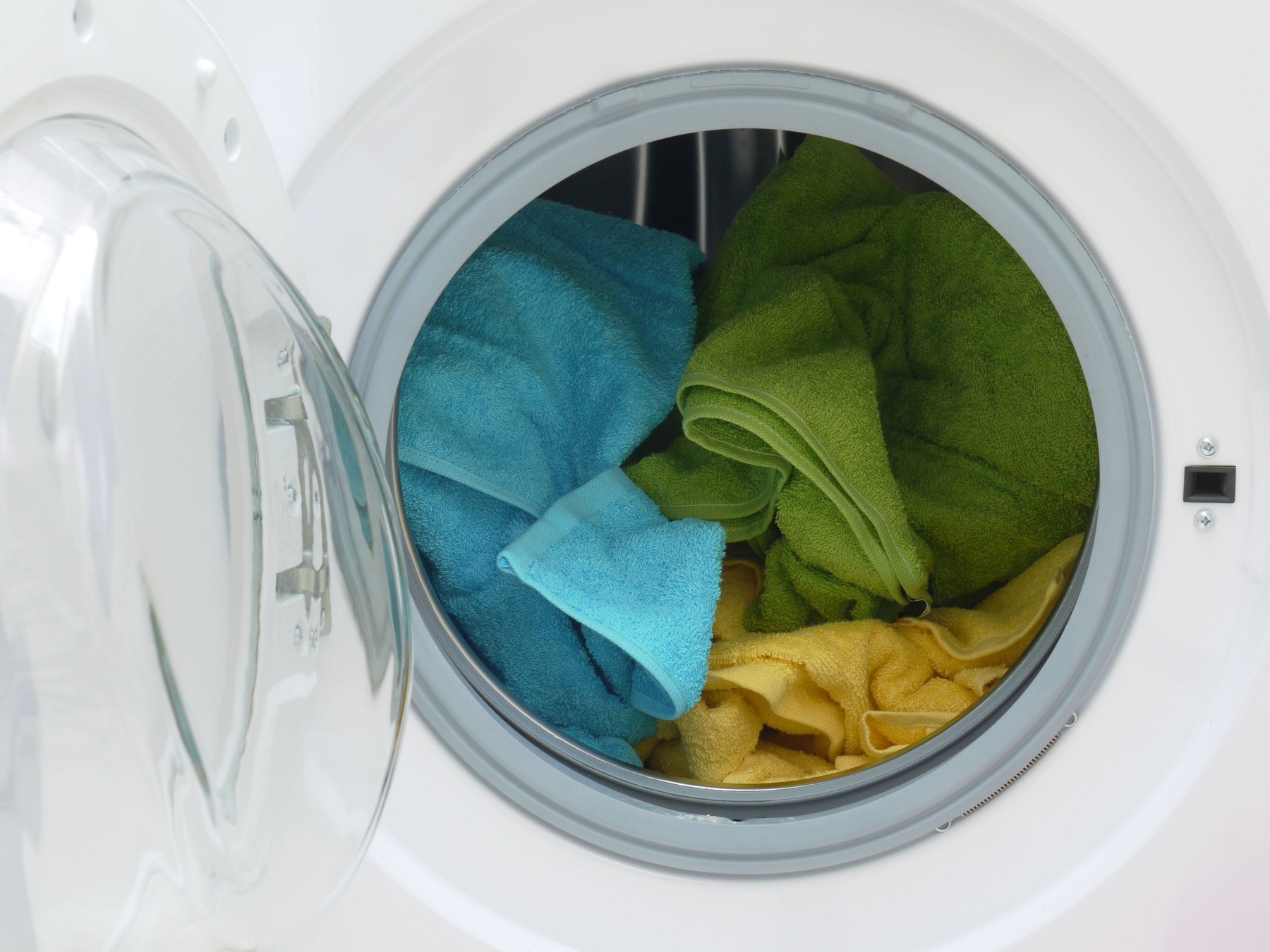 Colorful towels inside washing machine drum