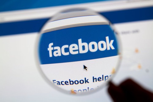 Facebook website page with Facebook logo and magnifying glass.