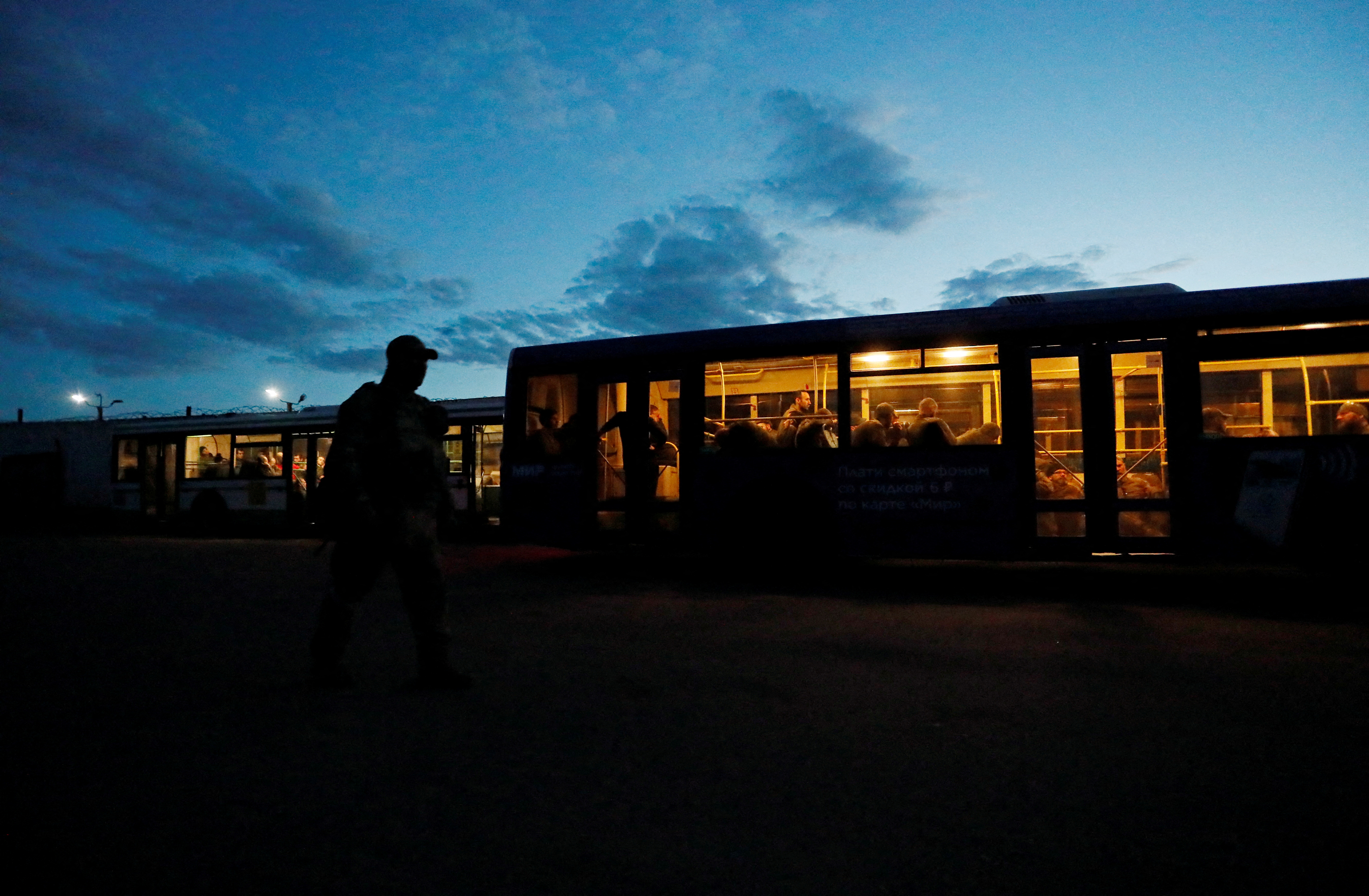 Buses carrying service members of Ukrainian forces who have surrendered after weeks holed up at Azovstal steel works arrive in Olenivka