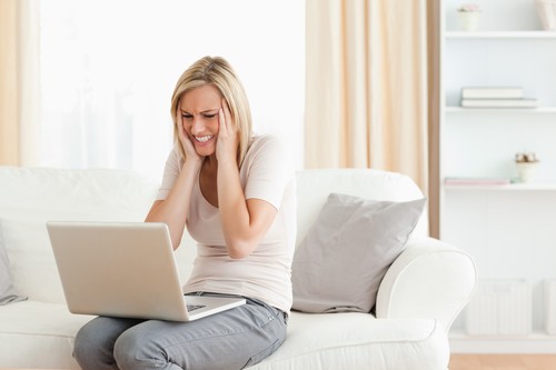 Upset woman using a laptop