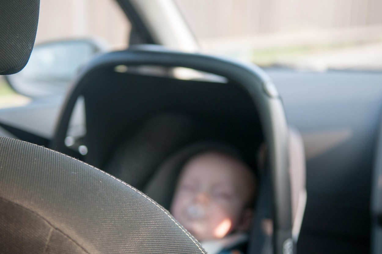 Child in rear facing car seat traveling safely on a journey