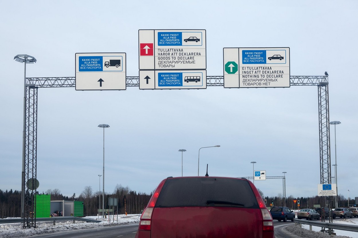 Cars stand long queue for passing red and green corridors  on of borderline checkpoint. Border crossing point Nuijamaa between Finland and Russia