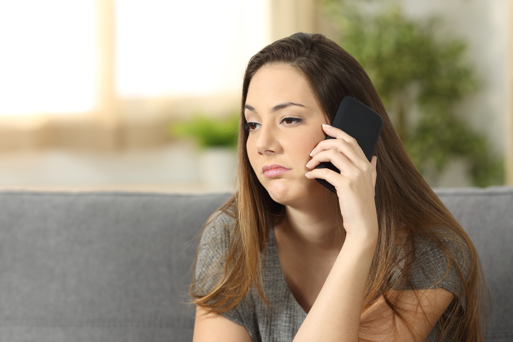 Woman bored during a phone call