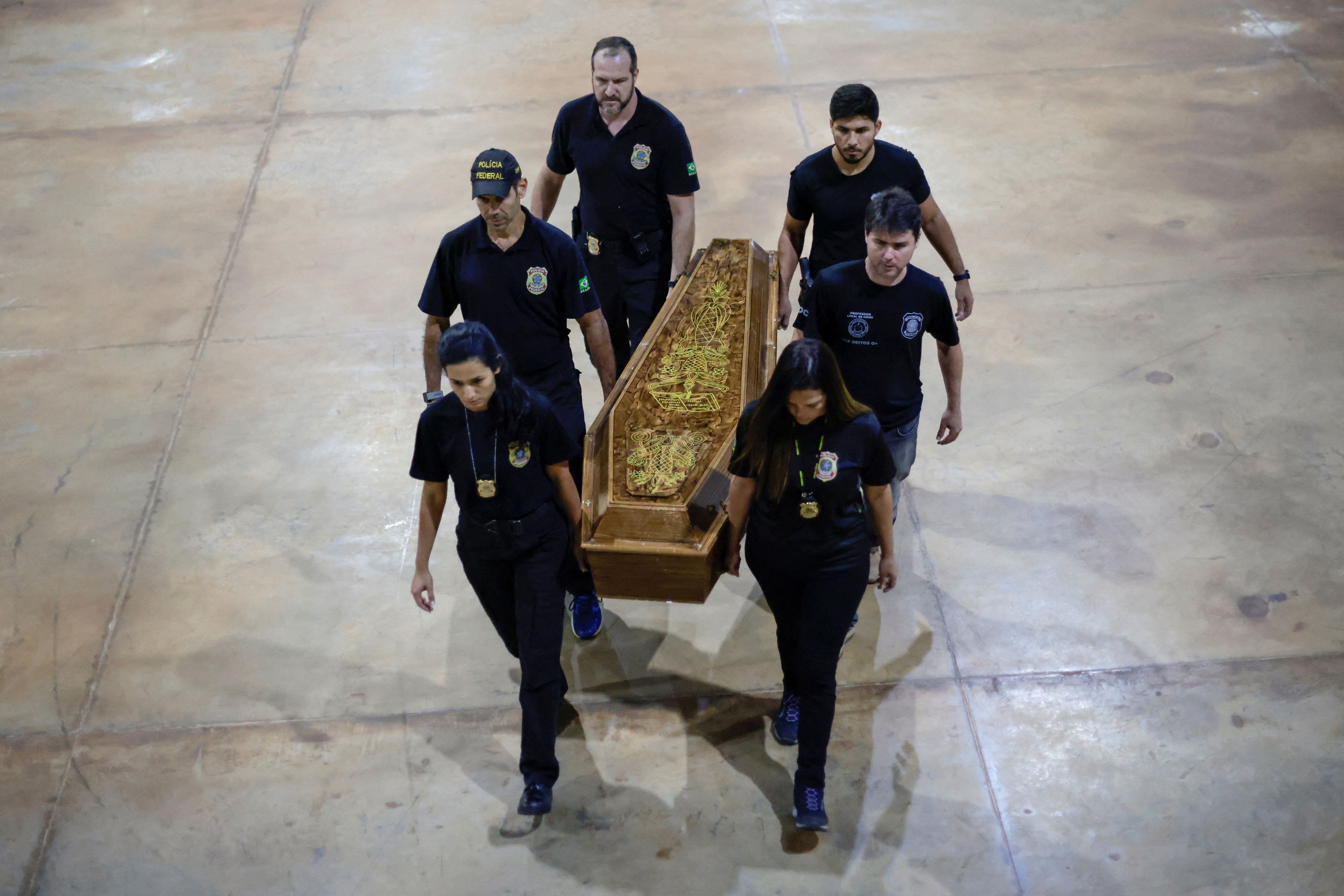 Federal Police officers carry a coffin containing human remains after a suspect confessed to killing British journalist Dom Phillips and Brazilian indigenous expert Bruno Pereira, in Brasilia