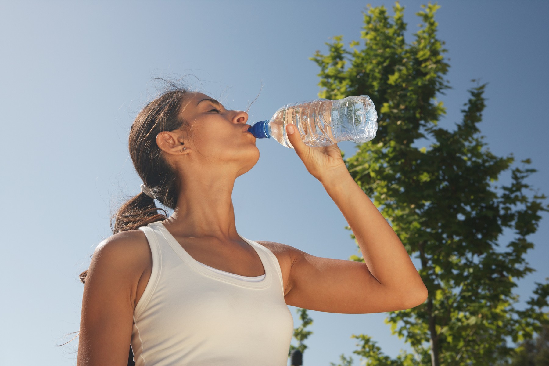 Woman drinking water outdoors