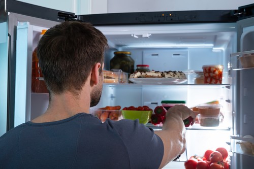 Man Taking Food From Refrigerator