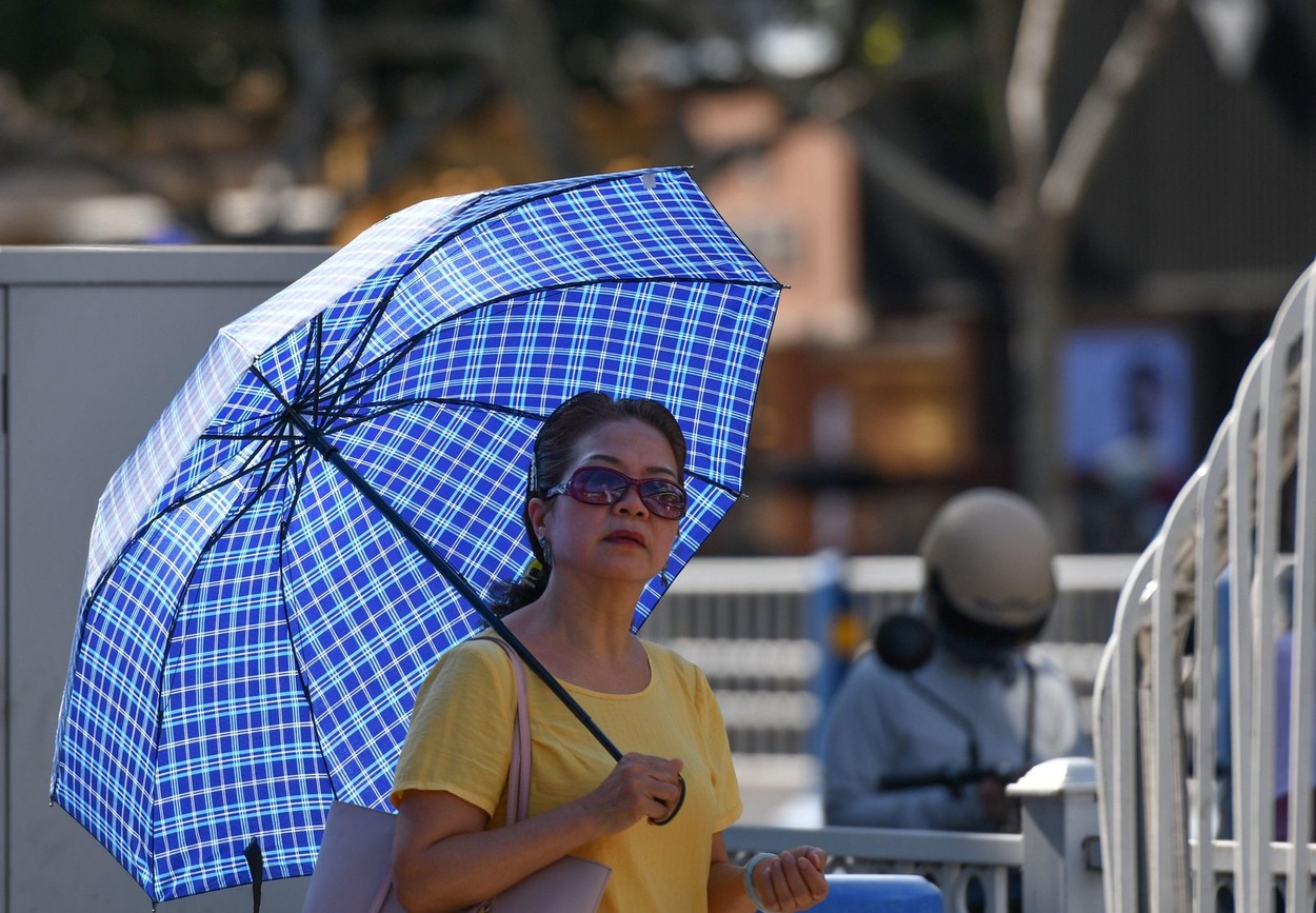 Fuyang, China. 07th Aug, 2022. A woman seen holding an umbrella during the hot weather. According to the forecast of China Central Meteorological Observatory, in the next 10 days, high temperature weather will continue in some parts of China, with the max