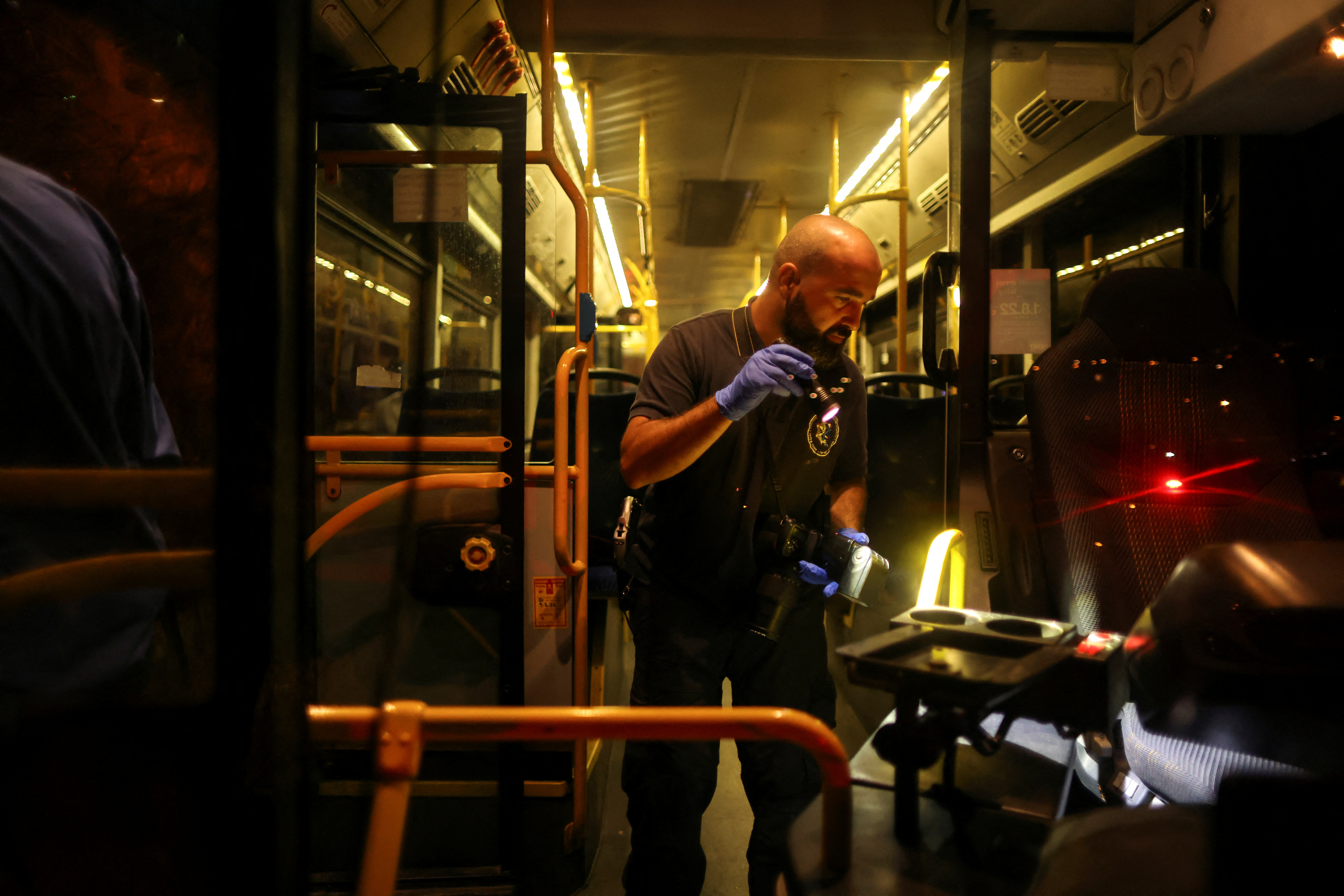 An Israeli police officer checks a bus following an incident in Jerusalem