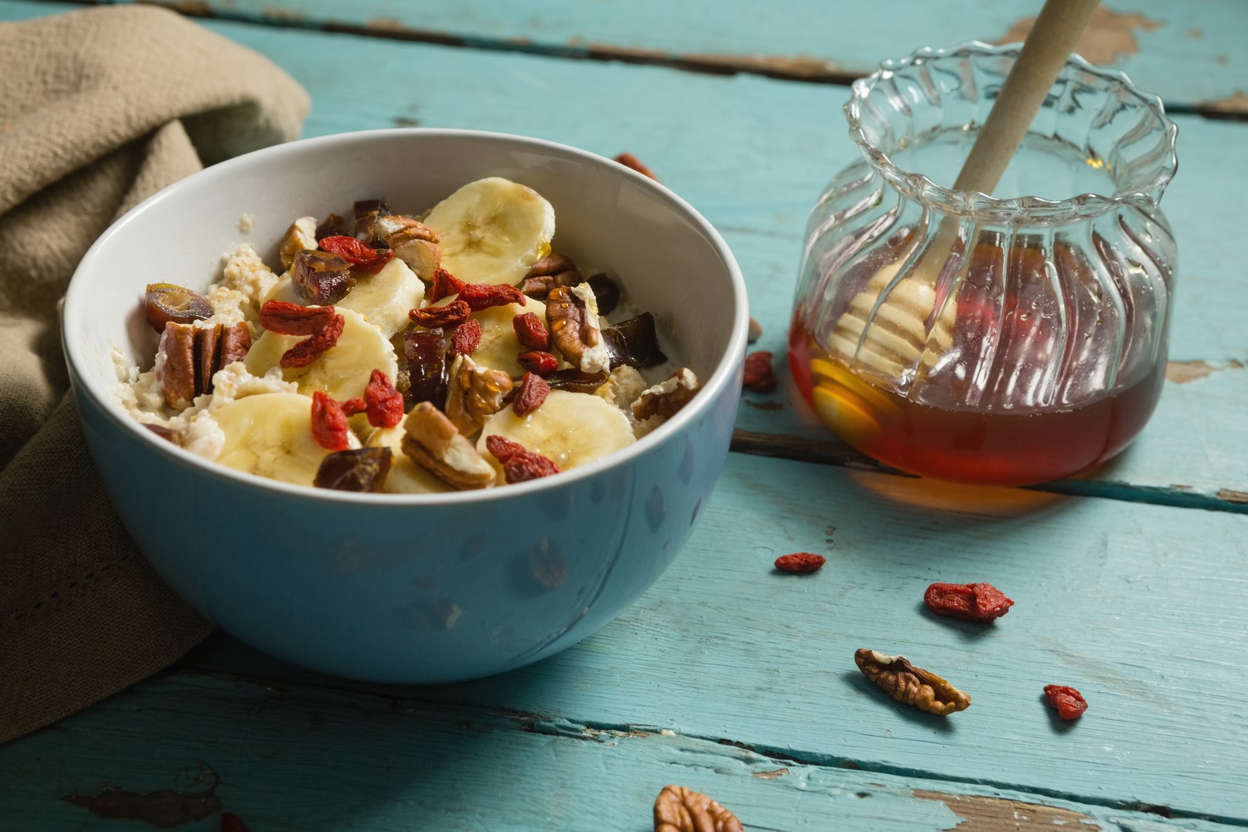 Fruit cereal and honey on a wooden table