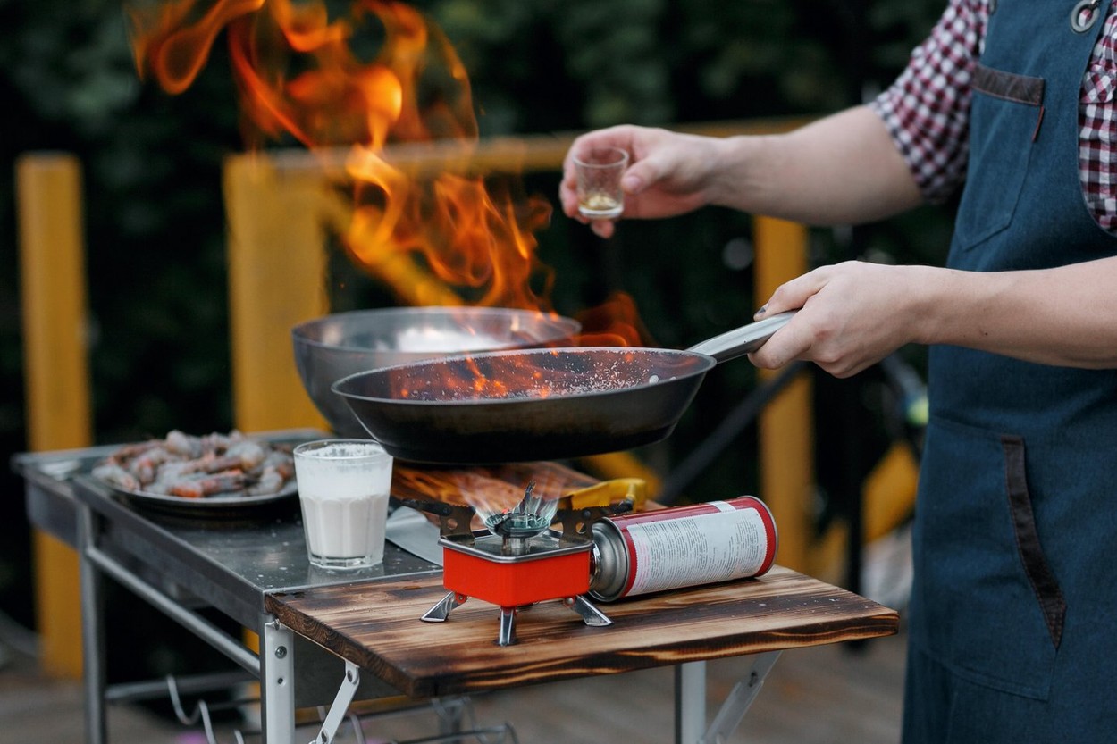 Flambe. Fried seafood on iron pan. chief cook pours the alcohol and fire.