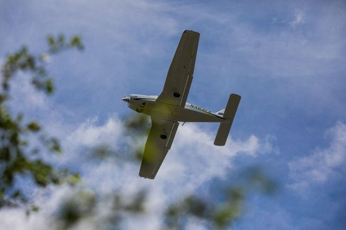Small Plane Flies Overhead on Sunny Summer Day