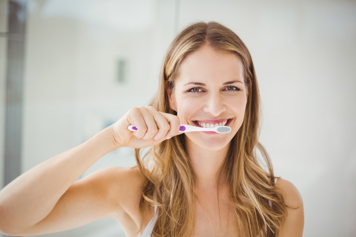 Young woman brushing teeth