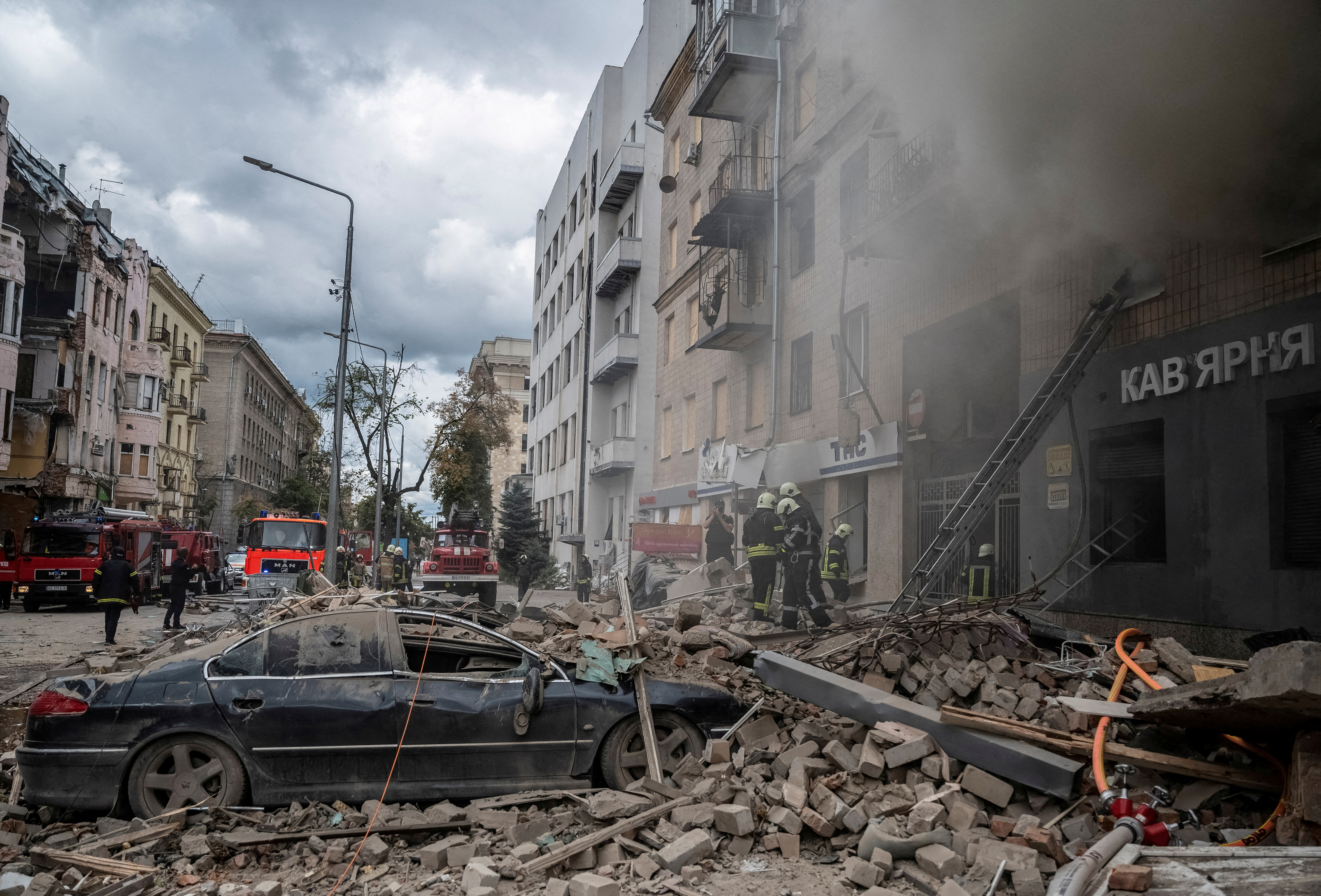 FILE PHOTO: Firefighters work at the site of a residential building hit by a Russian military strike in Kharkiv