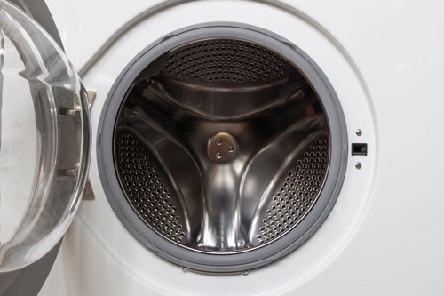 Open door in an empty washing machine.