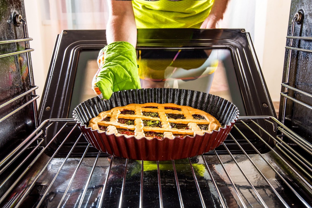 Housewife preparing cakes in the oven at home, view from the inside of the oven. Cooking in the oven.