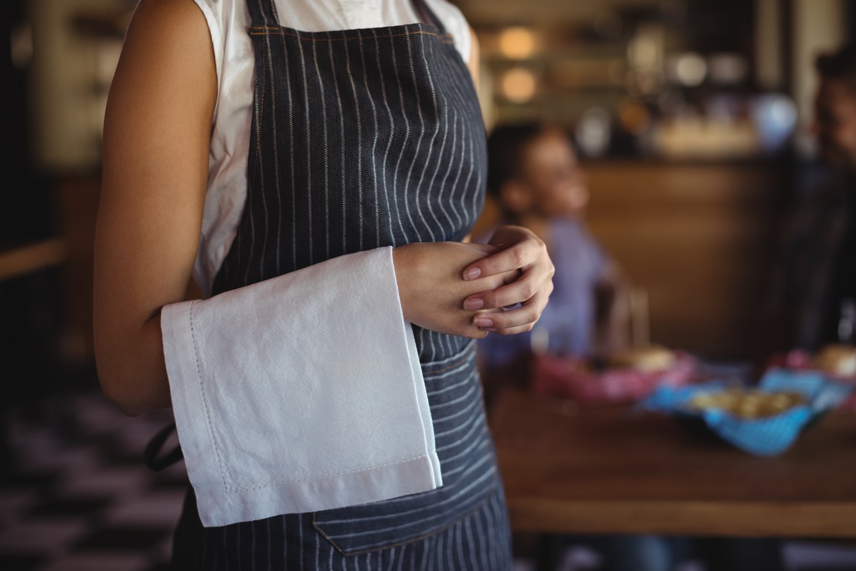 Waitress with napkin standing at restaurant