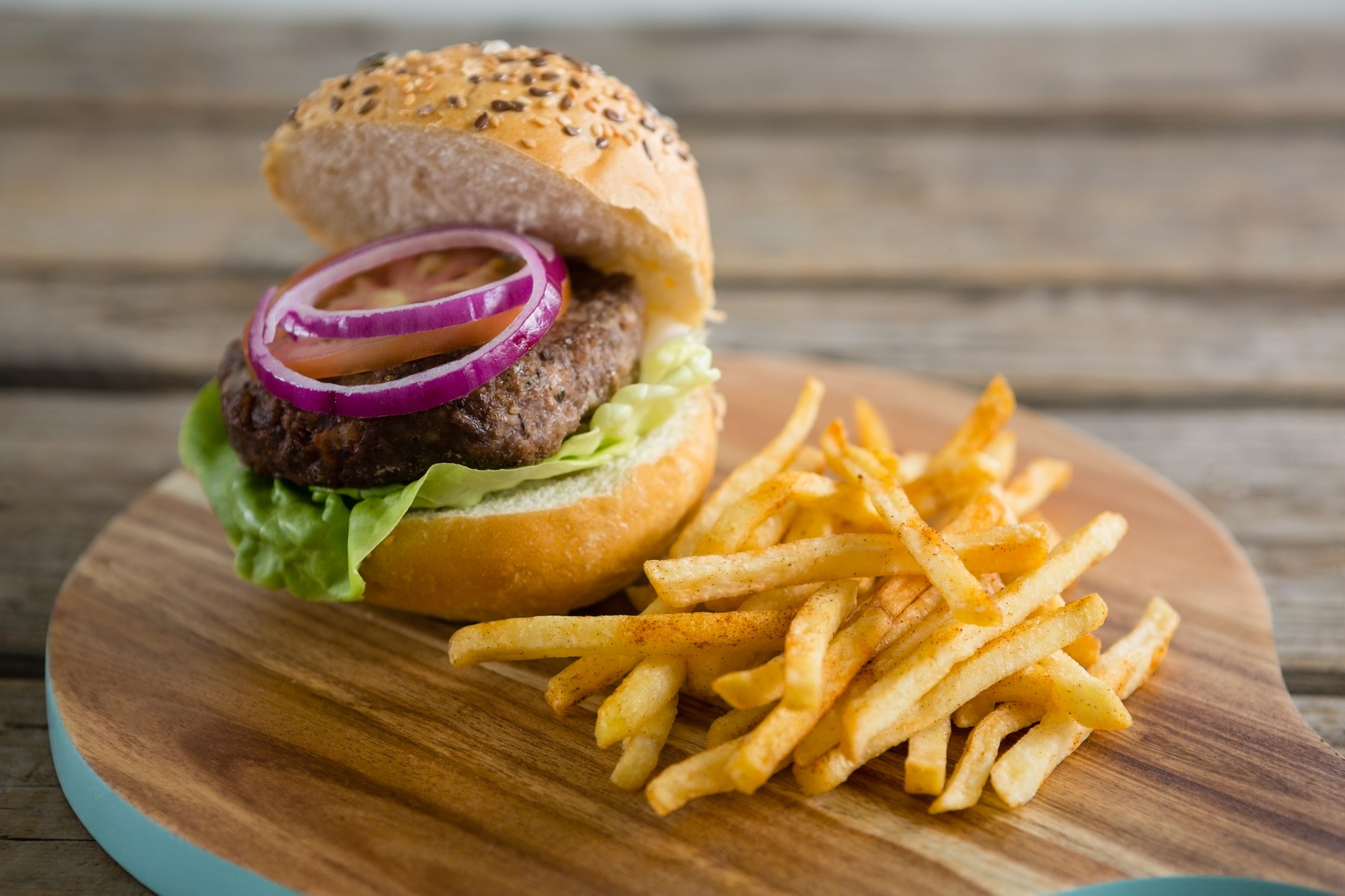 French fries with hamburger on cutting board
