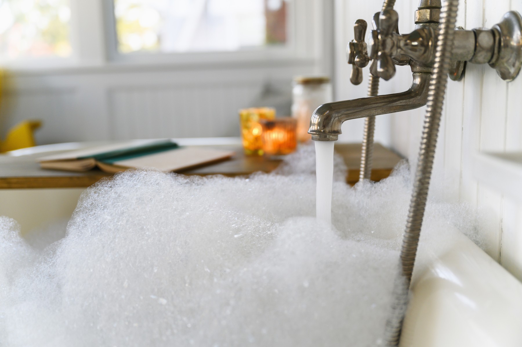 Bubble bath with book and candles