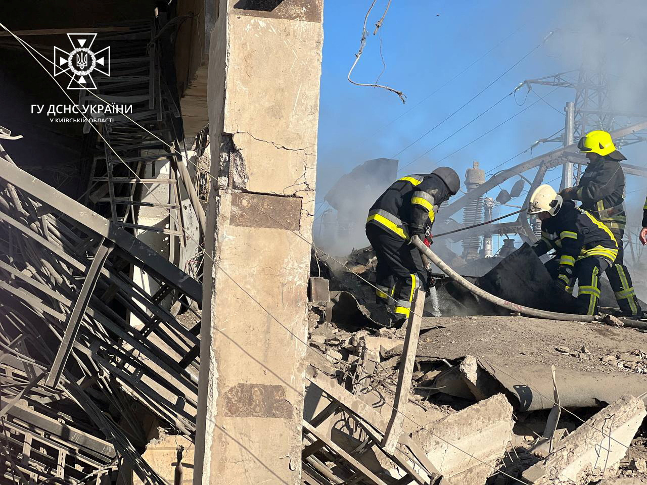 Firefighters work to put out a fire at energy infrastructure facilities, damaged by a Russian missile strike in Kyiv region in Ukraine