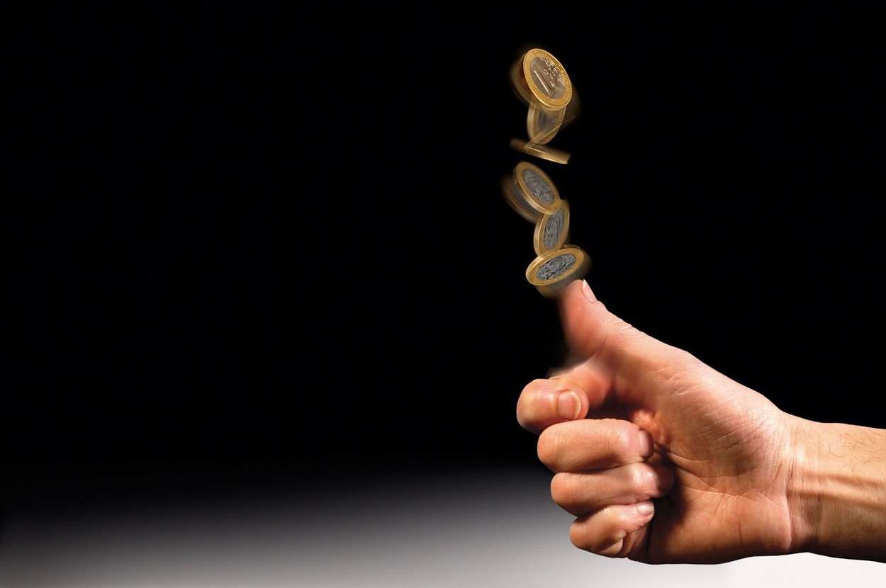 hand tossing Euro coin