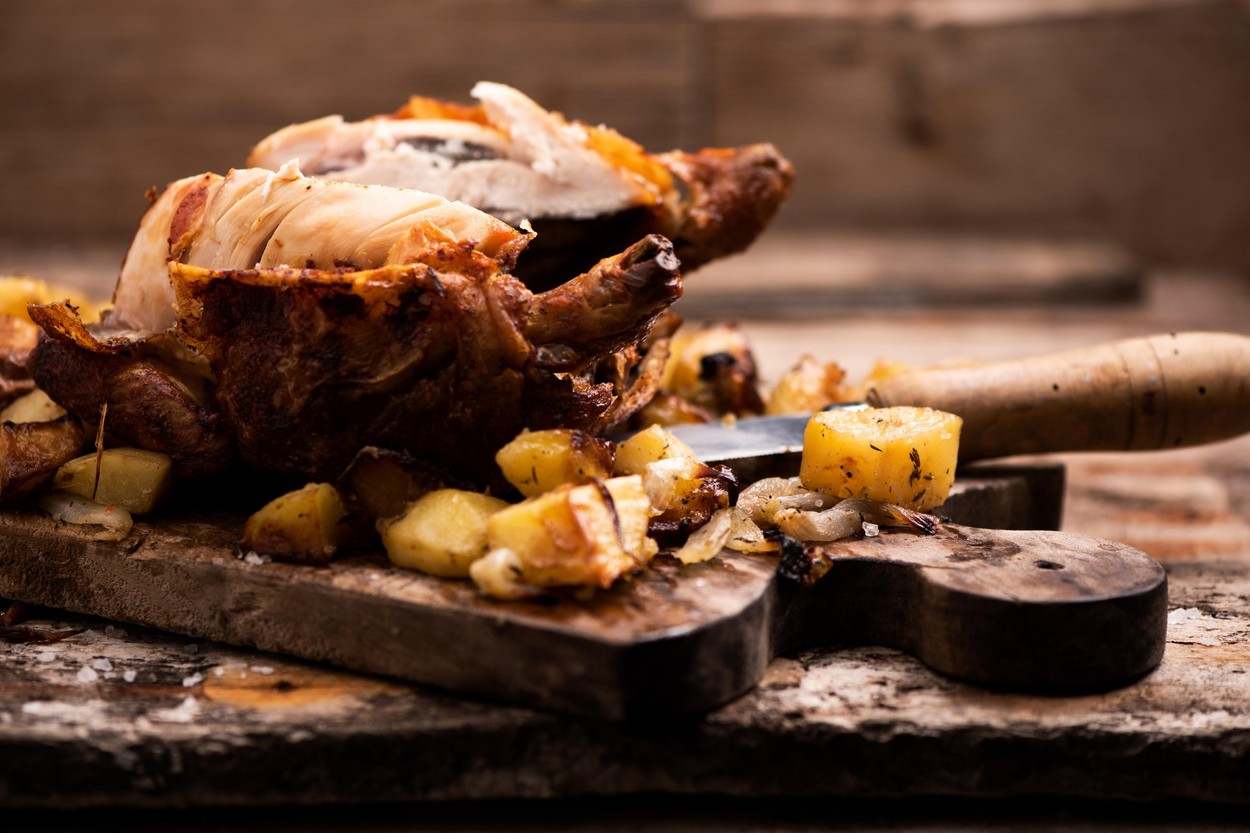 roasted chicken on wooden cutting board