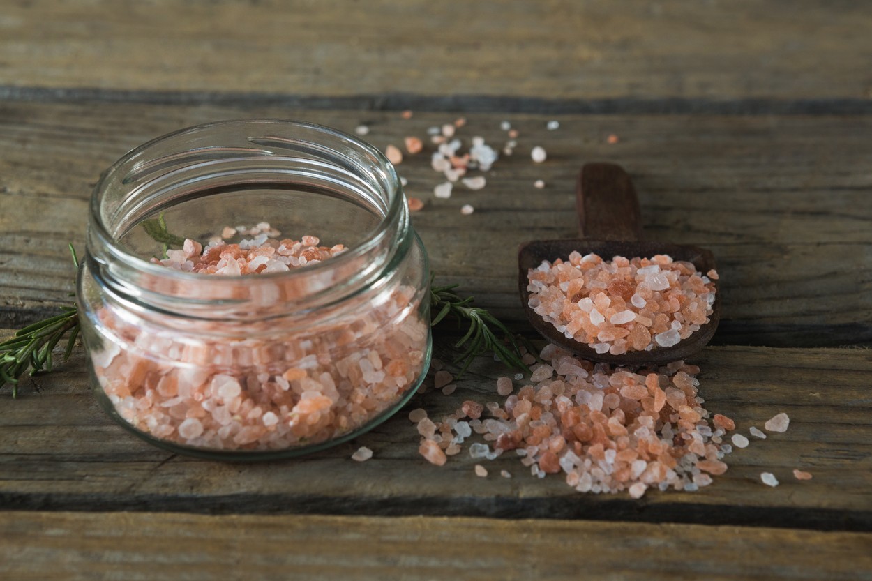 Himalayan salt and rosemary on wooden table